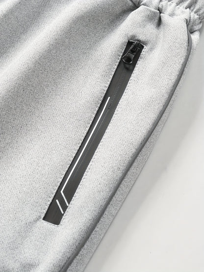 Տղամարդու առօրյա սպորտային հագուստի հավաքածու՝ Գարուն/աշուն՝ կանգնած օձիքով բաճկոն, երկու մասից բաղկացած հավաքածու՝ ժապավենով ձգվող առաձգական գոտկատեղով տաբատով, տղամարդու վերին և ստորին հագուստ վազքի համար, կայծակաճարմանդով գրպանի դիզայն